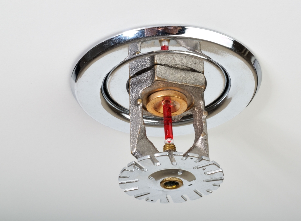 close up of fire sprinkler on white roof