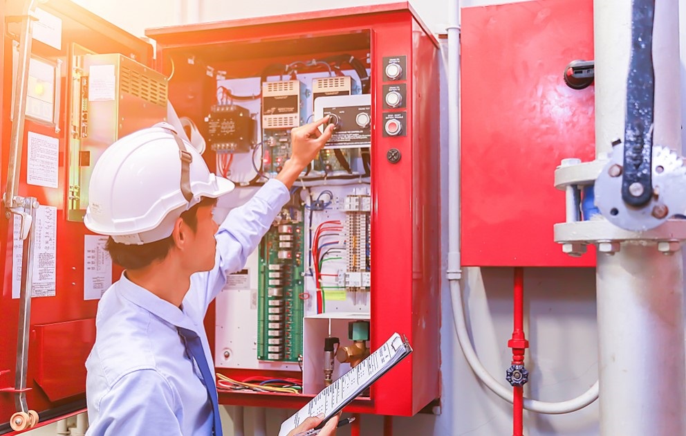 engineer checking fire alarm system