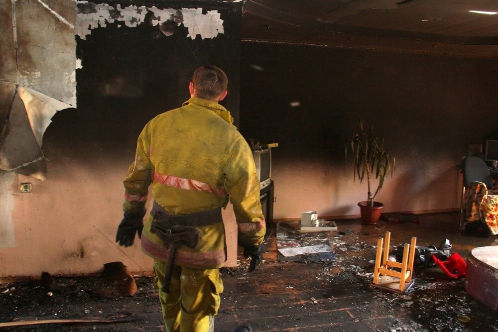 fire fighter in burnt room