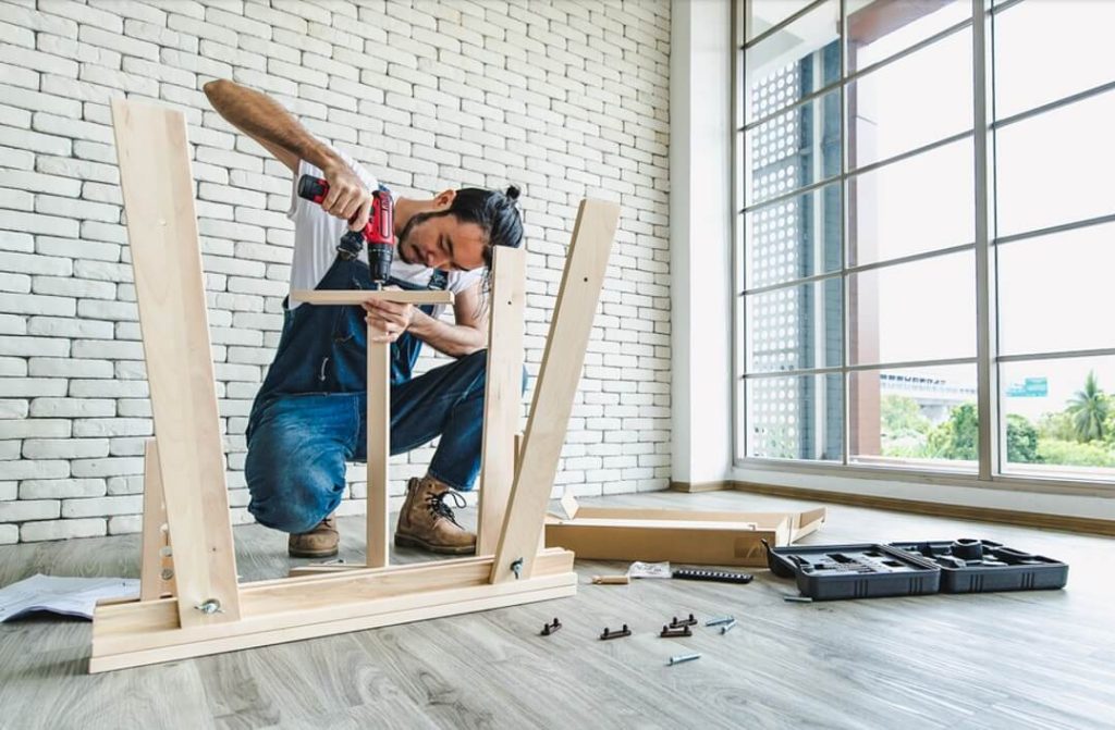 man making wooden frames