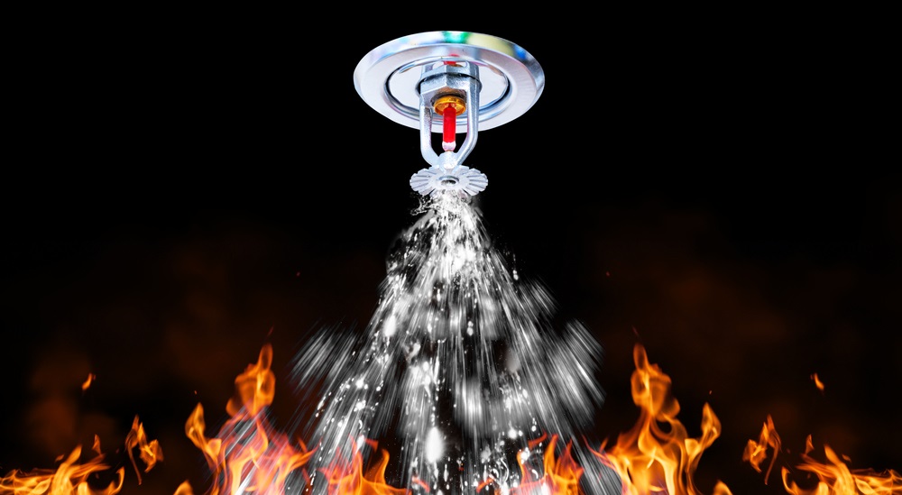 Fire sprinkler spraying water on fire