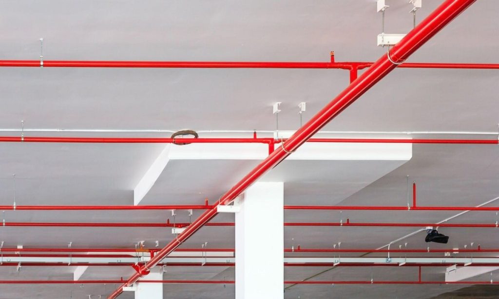 Red pipes for fire sprinkler system on ceiling