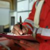 Fire inspector taking notes while testing fire sprinkler system