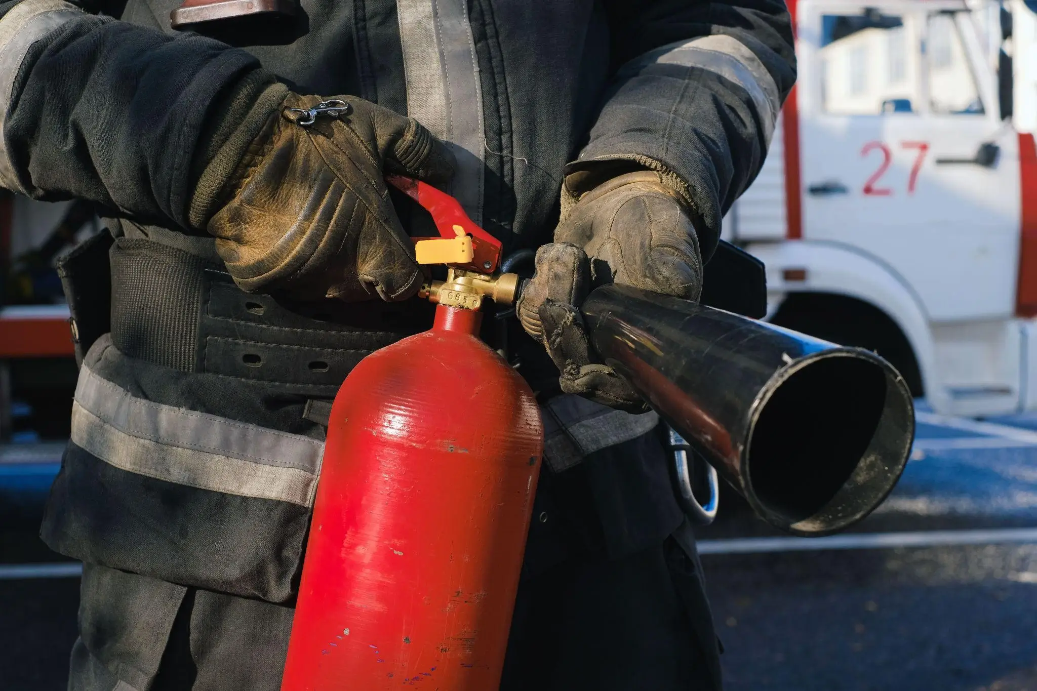 A firefighter demonstrating a fire extinguisher during Fire Prevention Week