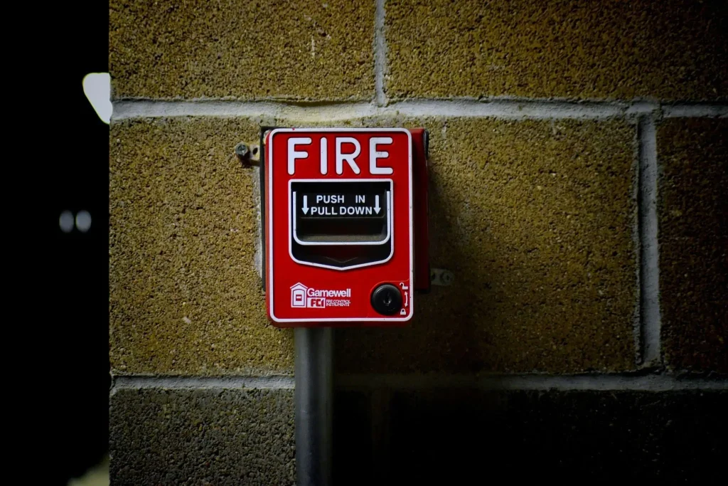 Fire alarm mounted to a cinder block wall